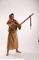 JOEL_ADAMSON STANDING POSE WITH SWORD AND CRUCIFIX